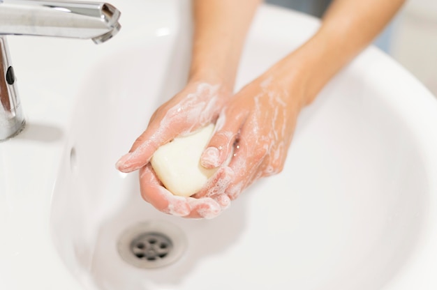 Person washing hands with soap