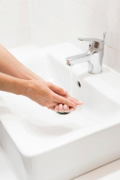 Person washing hands with soap