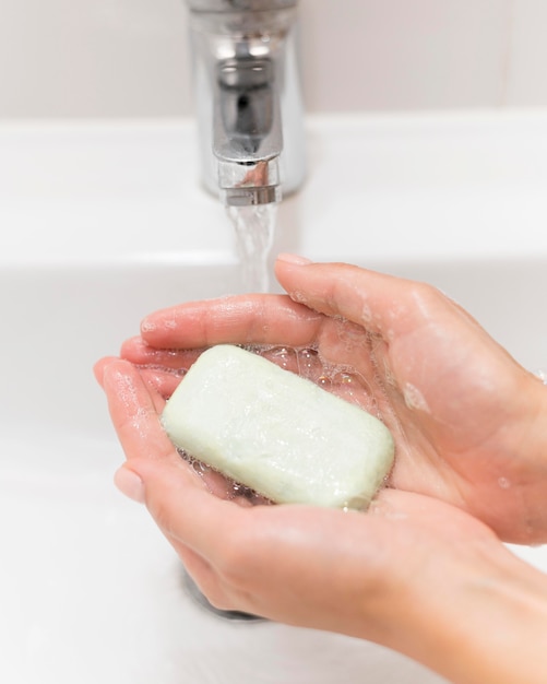 Person washing hands with soap