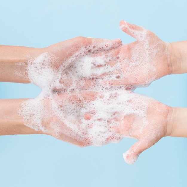 Person washing hands with soap