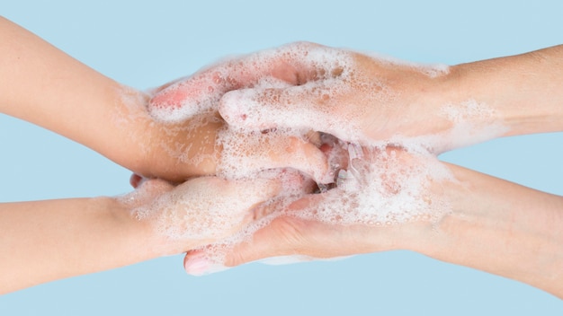 Person washing hands with soap