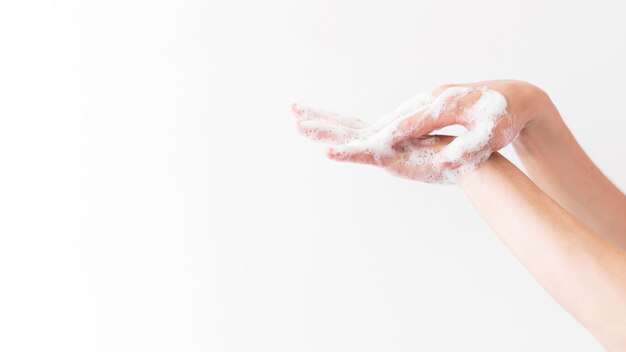 Person washing hands with soap