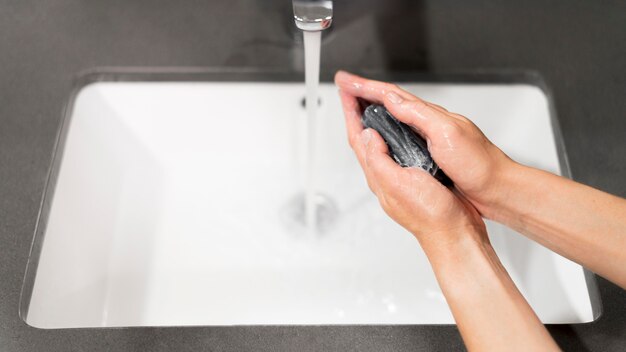 Person washing hands with soap