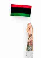 Free photo person waving the flag of pan-african flag