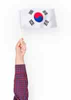 Free photo person waving the flag of south korea