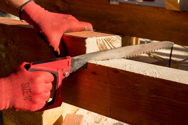 Person wearing protection gloves and using a drill