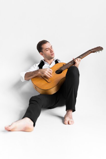 Person on white background playing the guitar