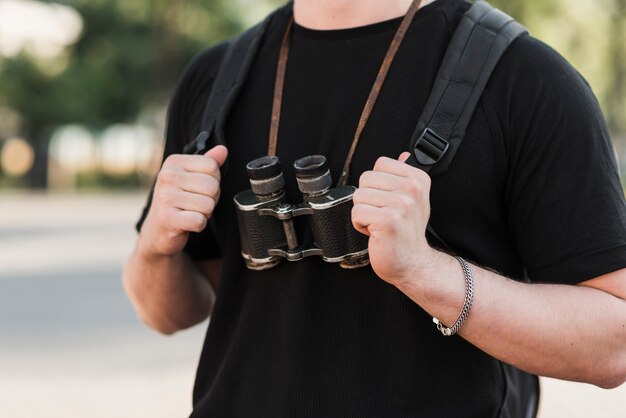 Person with backpack and binoculars