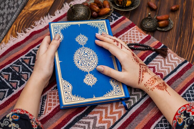 Free Photo person with mehndi holding quran near dates fruit