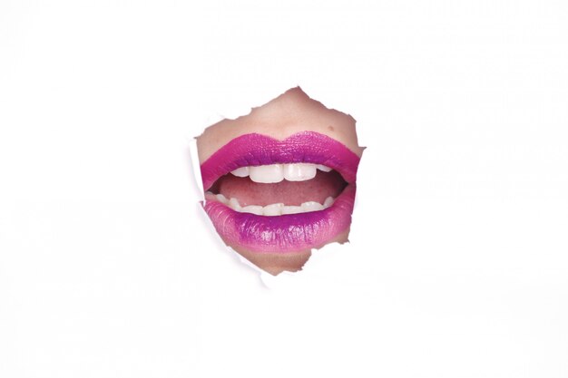 person with open mouth wearing purple lipstick on white