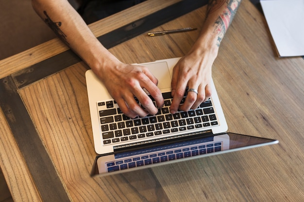 Person working on laptop at table 