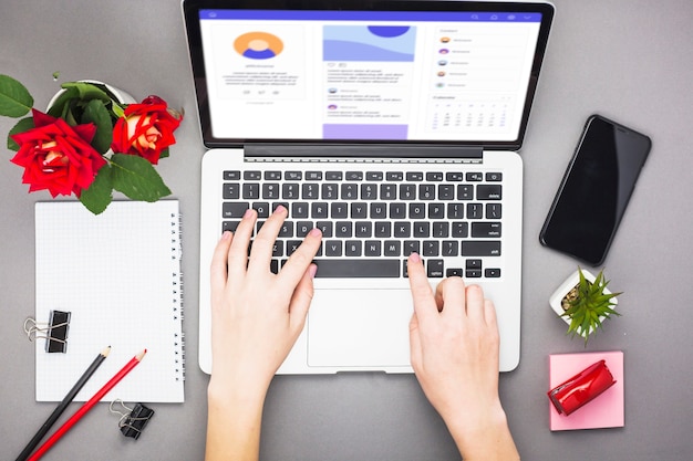 Person working on laptop at table 