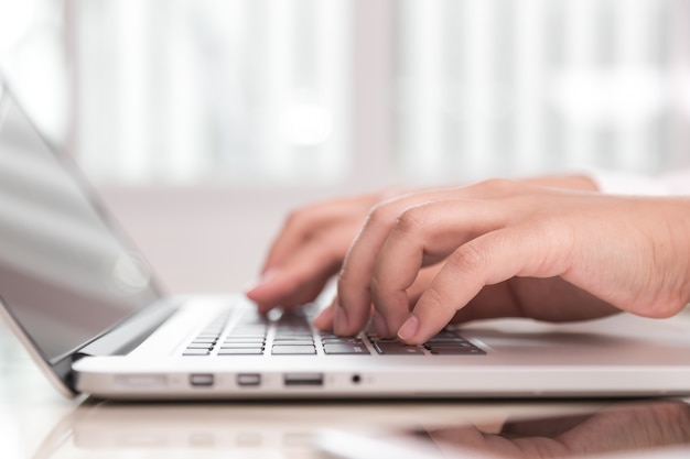 Person writing on a laptop