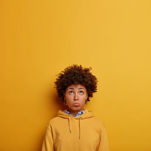 Free photo pessimistic afro american woman looks unhappily above