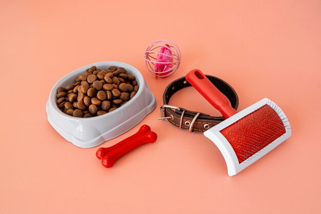 Pet accessories still life with food bowl and fur brush