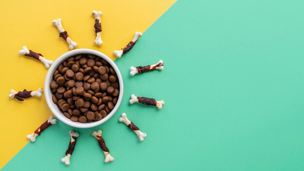 Pet accessories still life with food bowl and lots of chew bones for dogs