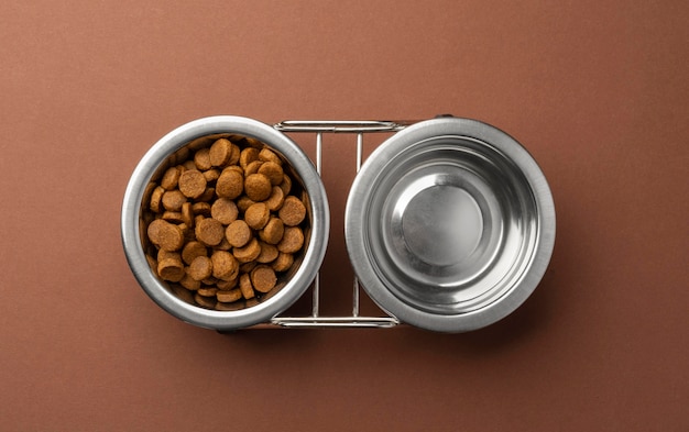 Free photo pet accessories still life with set of food bowls for dry food and water