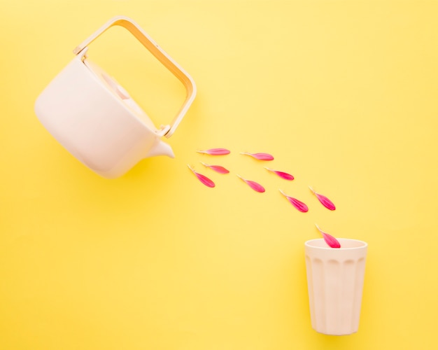 Petals pouring from pot into cup