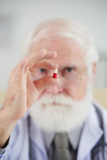 Pharmacist holding capsule