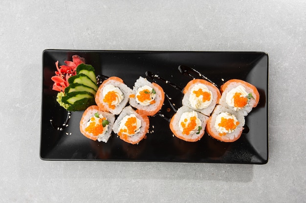 Philadelphia roll sushi with salmon, avocado, cream cheese and red caviar.