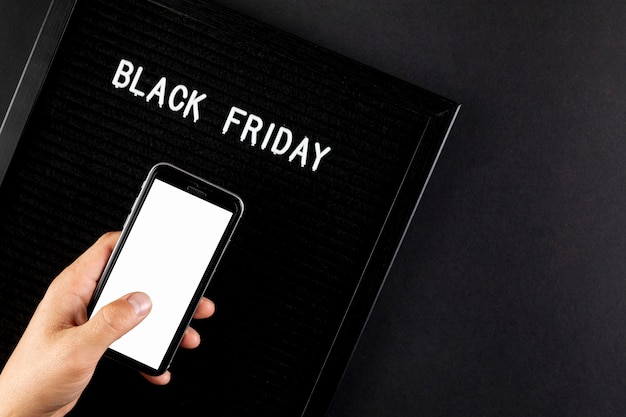 Free photo phone mock up next to a black friday sign