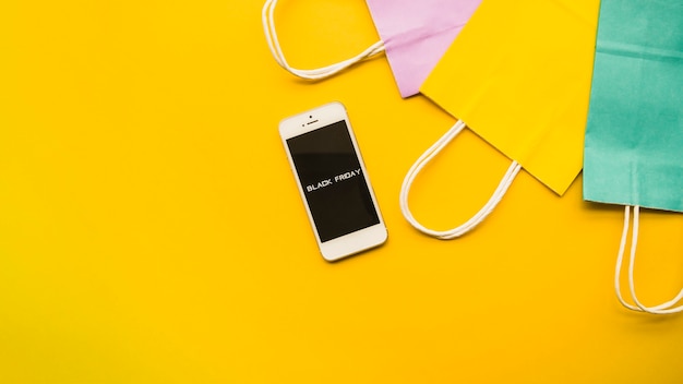 Phone with Black Friday inscription on table 