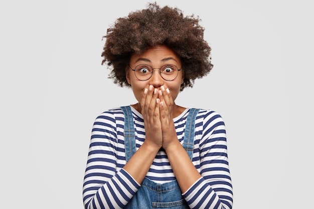 Foto di donna gioiosa eccitata stupita con acconciatura afro