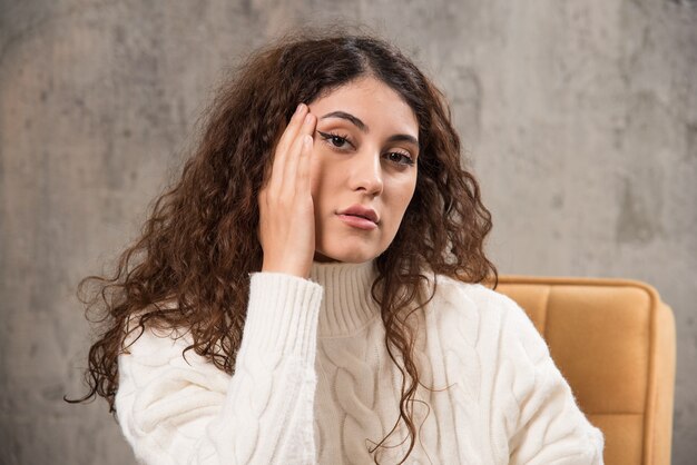 Photo of attractive lady sitting in comfy chair and posing