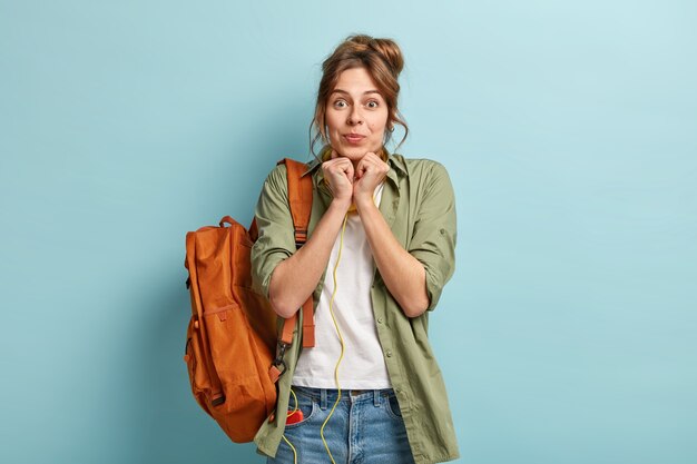 Photo of attractive young female with bag anticipates for pleasant surprise