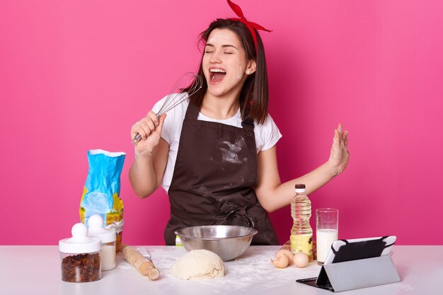 Photo of beautiful woman making cake.