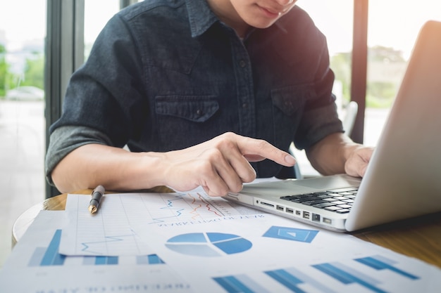 Photo businessman working with generic design notebook. Typing message, hands keyboard. Blurred background.