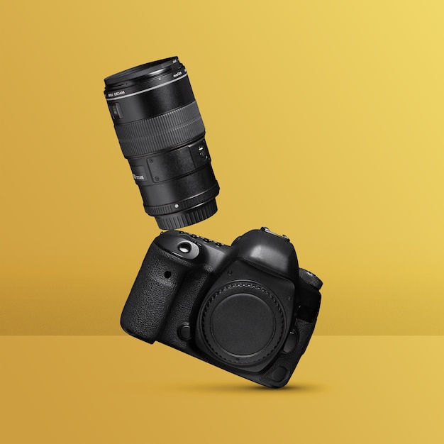 Free photo photo camera balancing with yellow background