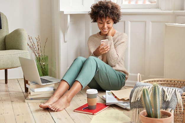 Photo of cheerful ethnic woman wears casual warm sweater