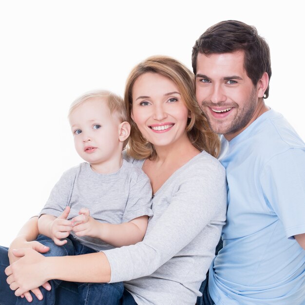 Photo of cheerful happy young parents with little child - isolated