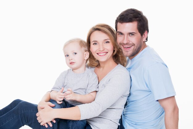 Photo of cheerful happy young parents with little child - isolated