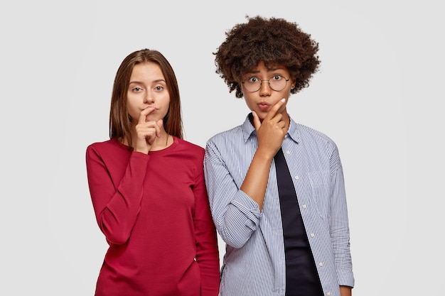 Photo of clueless two female friends of different race