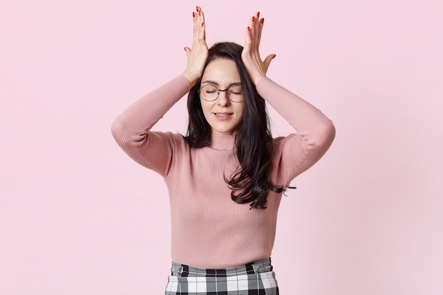 Photo of dissatisfied young dark haired woman