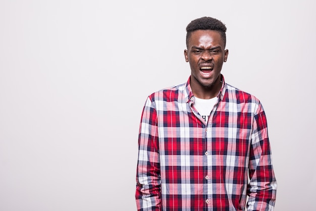 Free photo photo of emotional screaming young african man standing isolated.