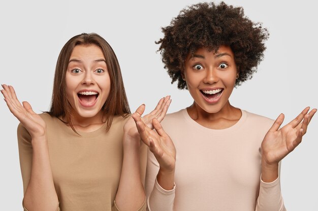 Photo of emotive females gesture with palms