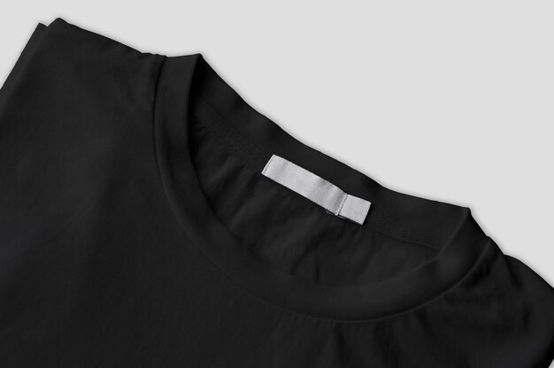 Free photo photo of folded black tshirt with white label isolated