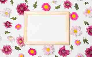 Free photo photo frame between composition of wonderful bright flowers and green leaves