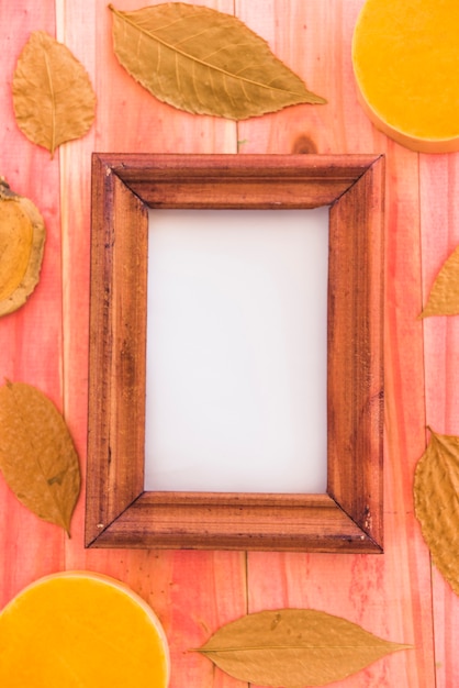 Photo frame between dry foliage and fruits