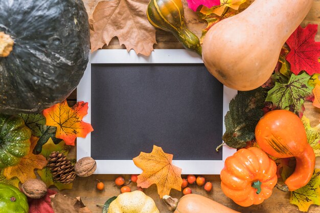 Photo frame between foliage and vegetables