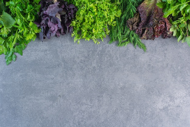 Photo of fresh healthy green vegetables on stone background.