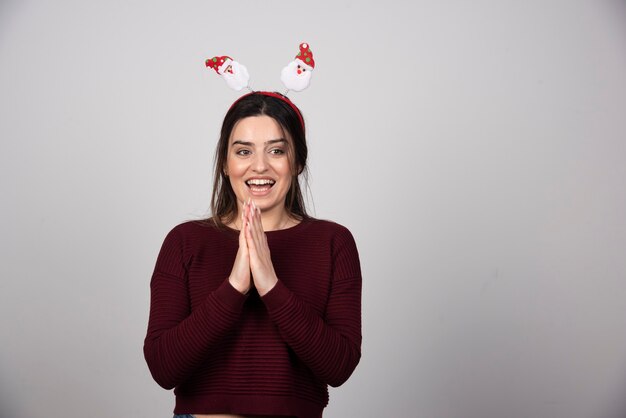 Photo of glad cheerful woman wearing Christmas headband .