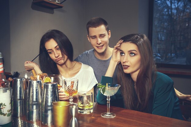 Photo of joyful friends in the bar or at pub communicating with each other