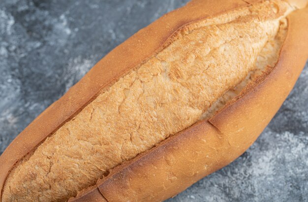 Photo of loaf of bread on grey background. High quality photo