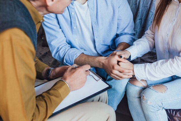 Photo of people hands holding on meeting with psychologist at home