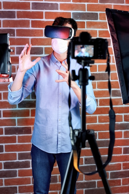 Photo session of a man in mask and vr headset