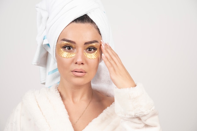 Photo of a woman with hydrogel eye patches .